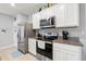 Modern kitchen featuring stainless steel appliances and granite countertops at 6895 Botanic Blvd, Harmony, FL 34773