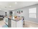 Spacious kitchen with a large island, granite countertops, and seamless flow into the living area at 6895 Botanic Blvd, Harmony, FL 34773