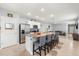 Modern kitchen with large center island and stainless appliances, seamlessly flowing into the living area at 6895 Botanic Blvd, Harmony, FL 34773