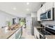 Bright kitchen featuring granite countertops, stainless steel appliances, and a spacious island with seating at 6895 Botanic Blvd, Harmony, FL 34773
