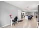 Open-concept living room with tile flooring and a modern island with barstool seating at 6895 Botanic Blvd, Harmony, FL 34773