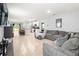 Open-concept living area connecting kitchen and sitting area with stylish decor and ample seating at 6895 Botanic Blvd, Harmony, FL 34773