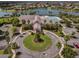 Aerial view of the community clubhouse, showcasing a pool, lake, and surrounding residential area at 8456 Norwich Way, Mount Dora, FL 32757