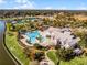 Community aerial view showcasing clubhouse, pool, bocce ball, pickleball, tennis courts, and lakes at 8456 Norwich Way, Mount Dora, FL 32757