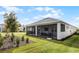 Exterior showcasing a screened patio with comfortable furniture and a well-maintained lawn at 8456 Norwich Way, Mount Dora, FL 32757