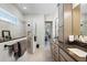 Contemporary bathroom showcasing dual vanities, a glass walk-in shower, and wood-look tile flooring at 8456 Norwich Way, Mount Dora, FL 32757