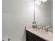 Bright bathroom featuring a vanity with a sink, mirror, and neutral countertops with decor at 8456 Norwich Way, Mount Dora, FL 32757