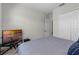 Bright bedroom featuring a closet and TV for relaxing evenings at 8456 Norwich Way, Mount Dora, FL 32757