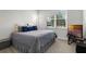 Comfortable bedroom with neutral walls, carpet flooring, a TV and a window with natural light at 8456 Norwich Way, Mount Dora, FL 32757