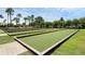 Bocce ball courts with green turf and wooden borders, set in a manicured lawn area at 8456 Norwich Way, Mount Dora, FL 32757