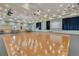 A dance floor with hardwood and neutral carpeting, lit with stage lighting and sconces at 8456 Norwich Way, Mount Dora, FL 32757