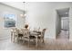 Formal dining room featuring wood table with seating for six and natural light from a window at 8456 Norwich Way, Mount Dora, FL 32757
