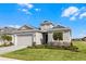 Charming single-story home with well-kept lawn, neutral exterior paint, and two-car garage at 8456 Norwich Way, Mount Dora, FL 32757