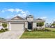 Beautiful single-story home with neutral paint, manicured lawn, and a two car garage at 8456 Norwich Way, Mount Dora, FL 32757