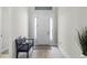 Bright foyer featuring wood-look tile, front door with sidelights, and a bench at 8456 Norwich Way, Mount Dora, FL 32757