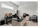 Well-lit home office featuring multiple work stations and ample storage space at 8456 Norwich Way, Mount Dora, FL 32757