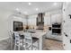 Well-designed kitchen with stainless appliances, light grey cabinets, island, and wood-look tile at 8456 Norwich Way, Mount Dora, FL 32757