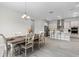 Open concept kitchen and dining area with wood-look tile and modern finishes at 8456 Norwich Way, Mount Dora, FL 32757