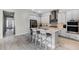 Spacious kitchen with an island, breakfast bar seating, and stainless steel appliances at 8456 Norwich Way, Mount Dora, FL 32757