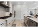 Bright kitchen featuring stainless steel appliances, gray cabinets, and an island with a sink at 8456 Norwich Way, Mount Dora, FL 32757
