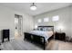 Comfortable main bedroom with natural light, tile floors, and a decorative rug at 8456 Norwich Way, Mount Dora, FL 32757