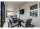 Covered patio with a view of the neighborhood, ample seating and a mounted television at 8456 Norwich Way, Mount Dora, FL 32757