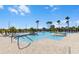 Community pool with palm trees and ample lounge seating for residents' relaxation at 8456 Norwich Way, Mount Dora, FL 32757