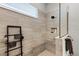 Elegant shower with a glass partition, rain shower head, built-in niche, and stylish gray tile at 8456 Norwich Way, Mount Dora, FL 32757
