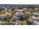 Two-story home with a well-manicured front yard, mature trees, and an attached two-car garage at 9026 Paolos Pl, Kissimmee, FL 34747