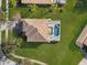 Aerial view of home, lawn, mature trees and screened in swimming pool at 9026 Paolos Pl, Kissimmee, FL 34747
