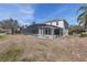Spacious screened in pool area features pool, hot tub, and backyard with trees at 9026 Paolos Pl, Kissimmee, FL 34747
