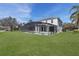 Spacious backyard with screened-in pool and well-manicured lawn, perfect for outdoor relaxation and entertainment at 9026 Paolos Pl, Kissimmee, FL 34747