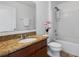 Bathroom featuring a granite countertop vanity, a tub with a shower, and mosaic tile at 9026 Paolos Pl, Kissimmee, FL 34747