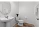 Well-lit half bathroom with a pedestal sink, ceramic tile floors and modern fixtures at 9026 Paolos Pl, Kissimmee, FL 34747