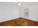 Cozy bedroom with ceiling fan, hardwood floors and a window providing natural light at 9026 Paolos Pl, Kissimmee, FL 34747