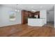 Open concept dining area featuring hardwood floors and a kitchen with wooden cabinetry at 9026 Paolos Pl, Kissimmee, FL 34747