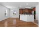 Kitchen and dining area with hardwood floors, wooden cabinets, and natural lighting at 9026 Paolos Pl, Kissimmee, FL 34747