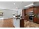 Spacious kitchen with stainless steel appliances, granite countertops, and adjacent dining area at 9026 Paolos Pl, Kissimmee, FL 34747