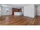 Spacious living room featuring hardwood floors and a view into the kitchen area at 9026 Paolos Pl, Kissimmee, FL 34747