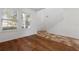 Bright living room with hardwood and tile flooring, a staircase, and large windows at 9026 Paolos Pl, Kissimmee, FL 34747