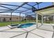 Screened-in patio area featuring a pool, hot tub, and covered seating area at 9026 Paolos Pl, Kissimmee, FL 34747
