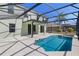 Screened-in pool area features pool, hot tub, and a covered lanai with backyard views at 9026 Paolos Pl, Kissimmee, FL 34747