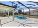 Screened-in pool area features pool, hot tub, and a covered lanai with backyard views at 9026 Paolos Pl, Kissimmee, FL 34747