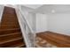 Hardwood staircase with white railing leading to the second floor and hardwood flooring at 9026 Paolos Pl, Kissimmee, FL 34747