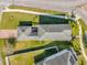 Overhead view of a home with a large roof and long driveway, surrounded by a well-maintained green lawn at 9862 Pecan Hickory Way, Orlando, FL 32832
