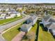 Aerial view of a well-maintained property, featuring a lush green lawn that stretches to the serene community lake at 9862 Pecan Hickory Way, Orlando, FL 32832