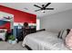 Bedroom with a queen-sized bed, ceiling fan, and colorful walls at 9862 Pecan Hickory Way, Orlando, FL 32832