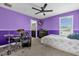 Colorful bedroom featuring a drum set, ceiling fan, and attached bathroom at 9862 Pecan Hickory Way, Orlando, FL 32832