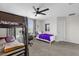 Shared bedroom featuring a bunk bed, a white bed, a desk, and a ceiling fan at 9862 Pecan Hickory Way, Orlando, FL 32832