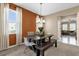 Bright dining room with a modern table, bench, and elegant window treatments at 9862 Pecan Hickory Way, Orlando, FL 32832